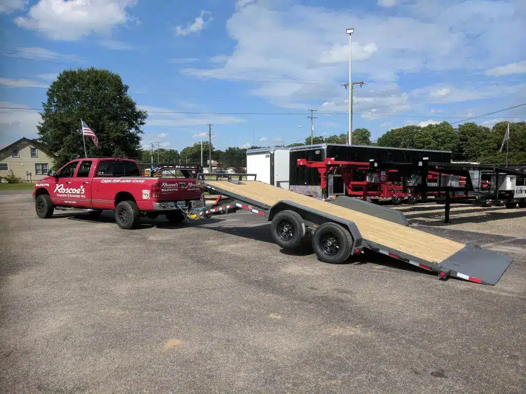 truck towing a trailer used to haul old cars safely